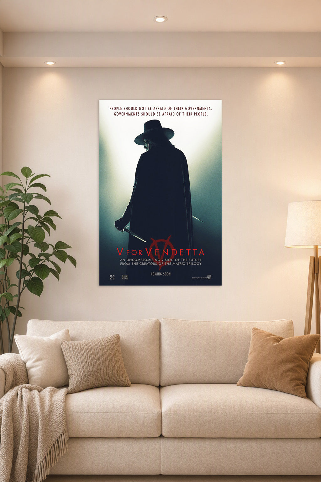V for Vendetta in a bright living room above a beige sofa.