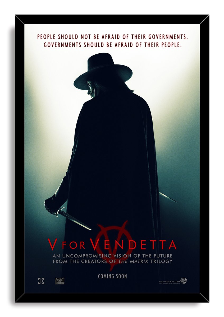 V for Vendetta framed wall art print presents a masked figure in a black cloak holding daggers, with red lettering and a black frame.