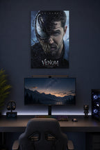 Venom Eddie Brock Tom Hardy in a gaming desk setup above a monitor.