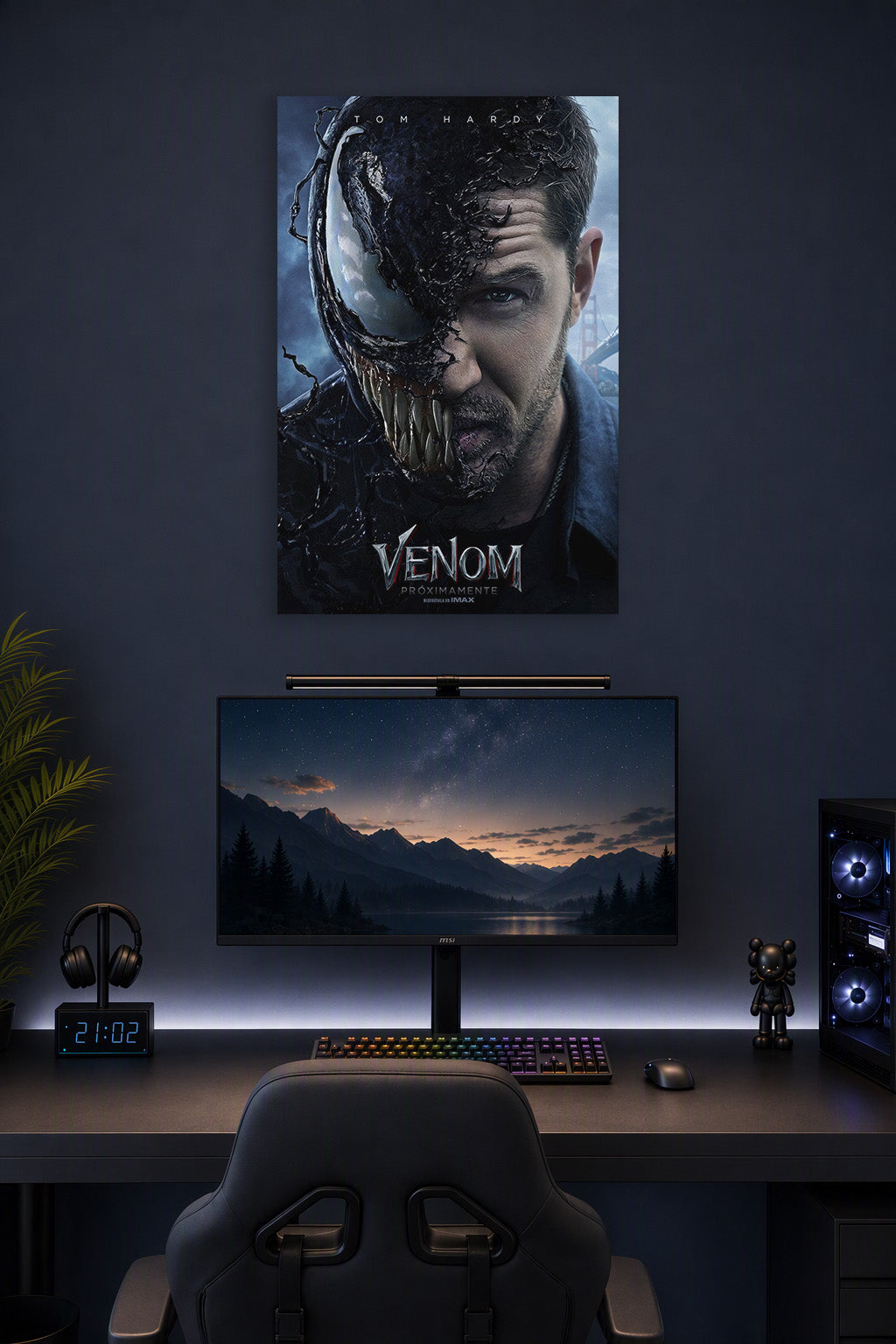 Venom Eddie Brock Tom Hardy in a gaming desk setup above a monitor.