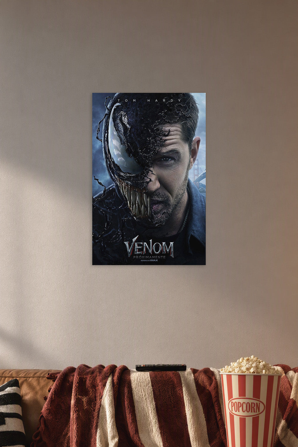 Venom Eddie Brock Tom Hardy in a cozy movie room above a brown sofa with popcorn.