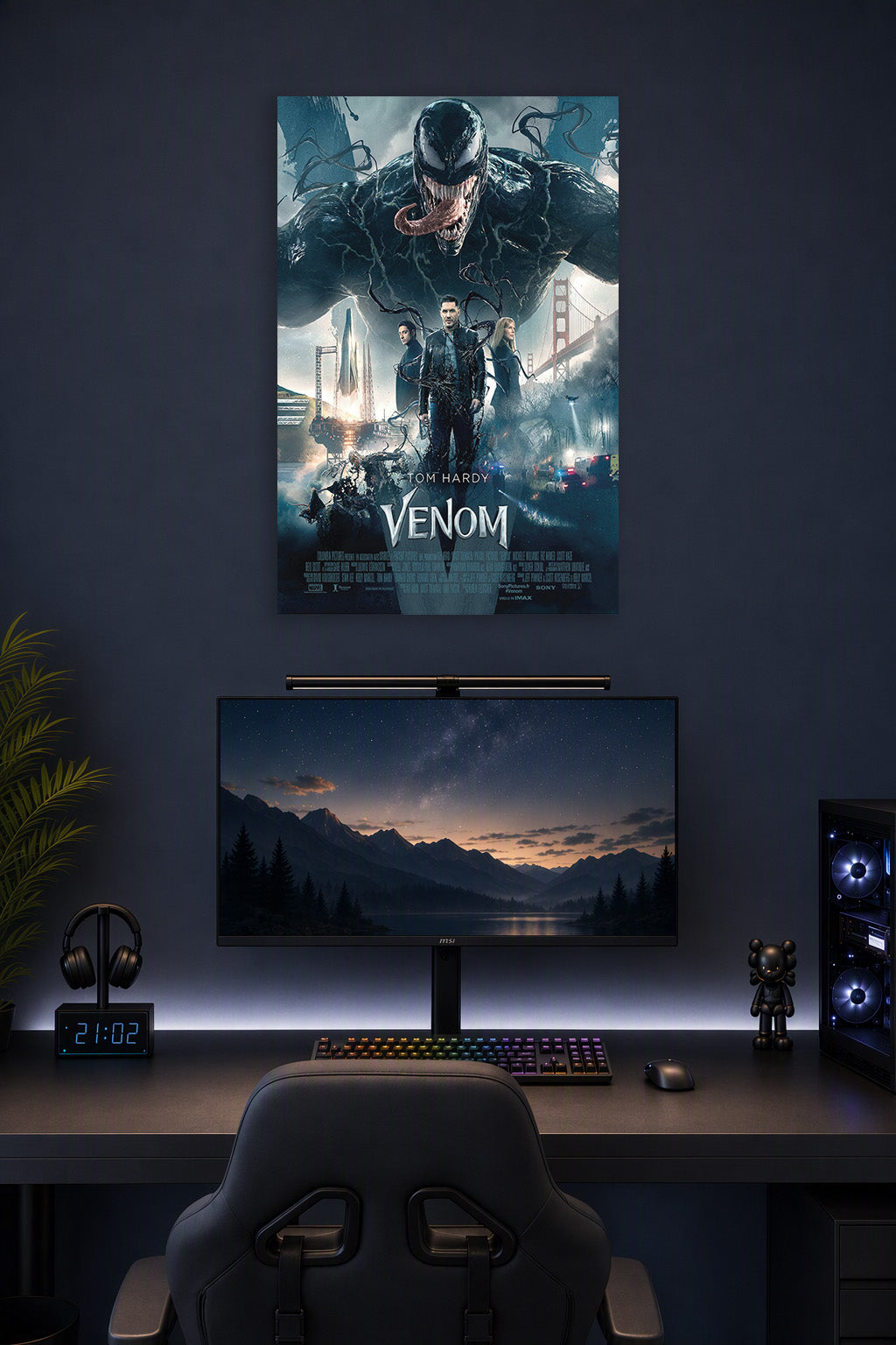 Venom Movie Tom Hardy in a gaming desk setup above a monitor.