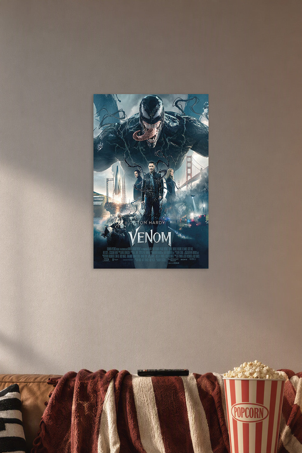 Venom Movie Tom Hardy in a cozy movie room above a brown sofa with popcorn.