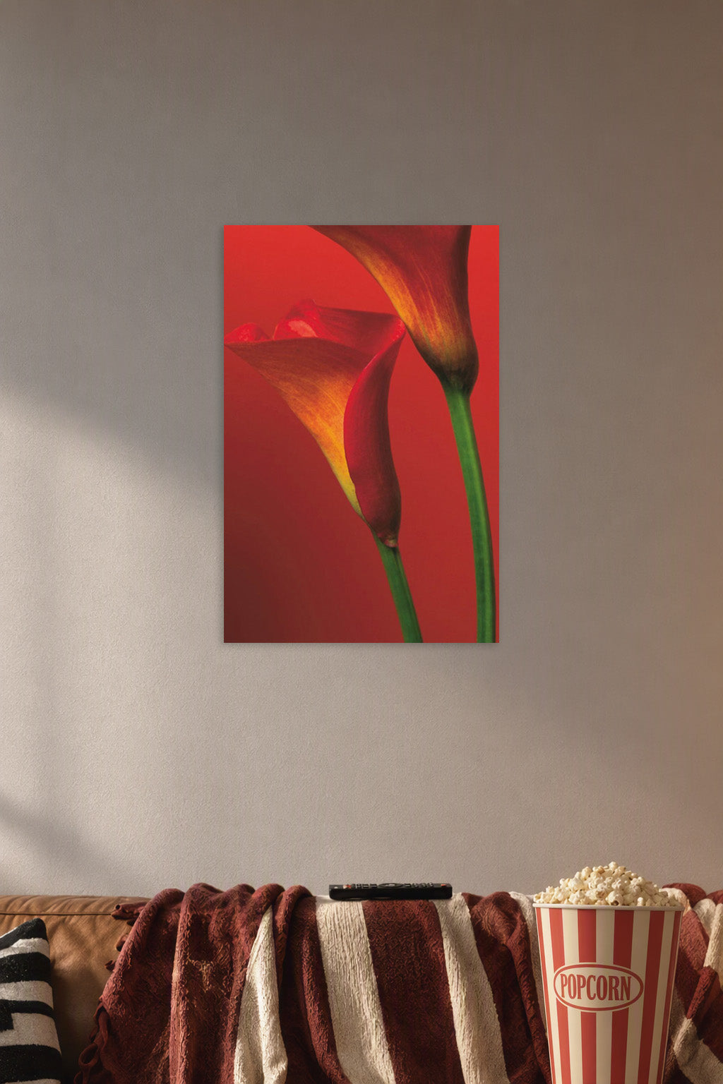 Vibrant Calla Lilies in a cozy movie room above a brown sofa with popcorn.
