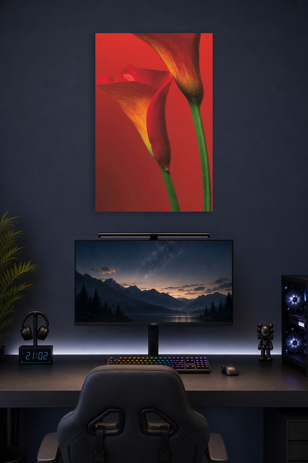 Vibrant Calla Lilies in a gaming desk setup above a monitor.