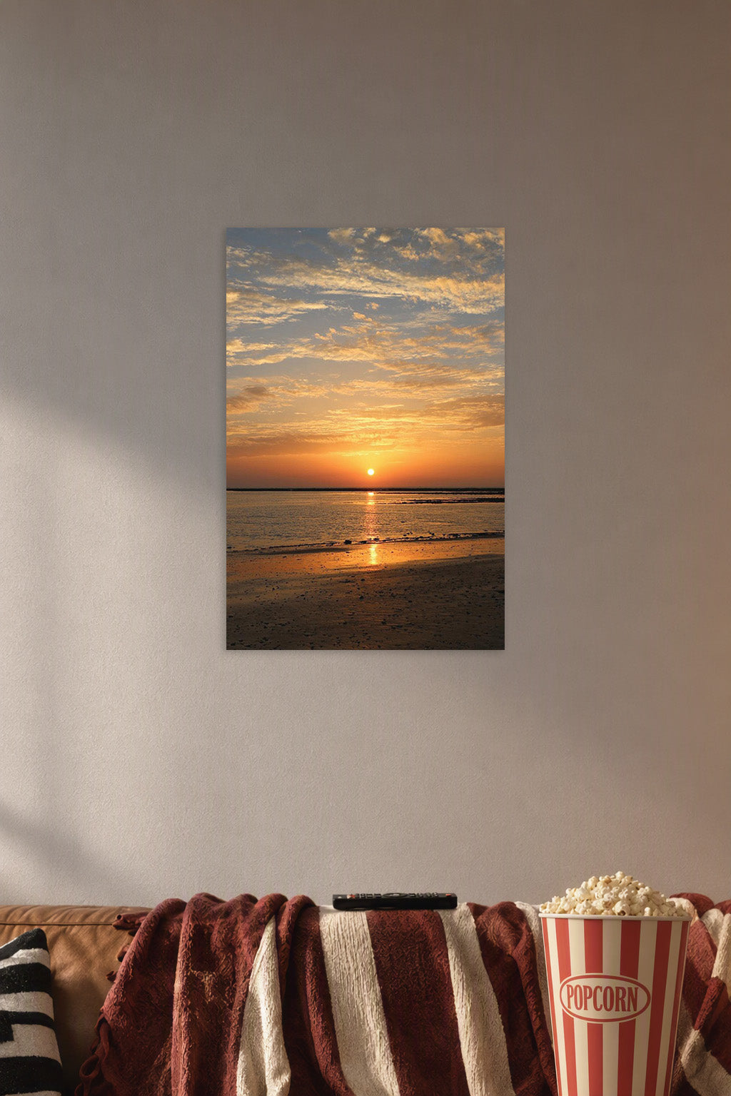 Vibrant Sunset Seascape in a cozy movie room above a brown sofa with popcorn.