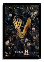 Vikings framed wall art print depicts a crowded warrior battle around a gold V symbol, set in a sleek black frame.