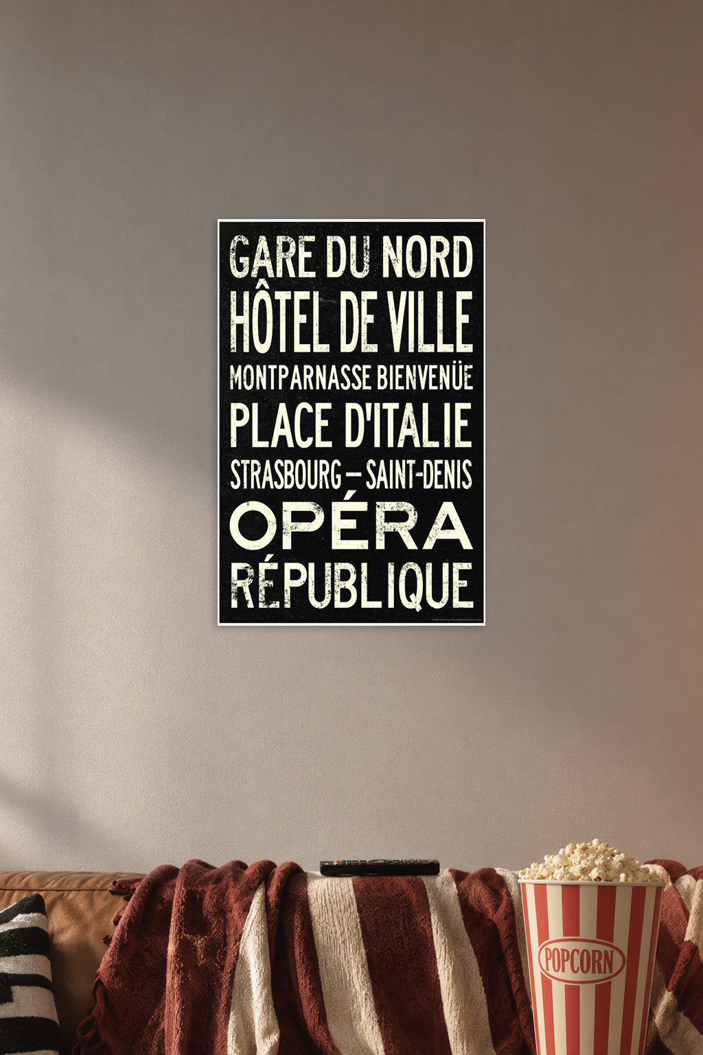 Vintage Paris Metro Stations in a cozy movie room above a brown sofa with popcorn.