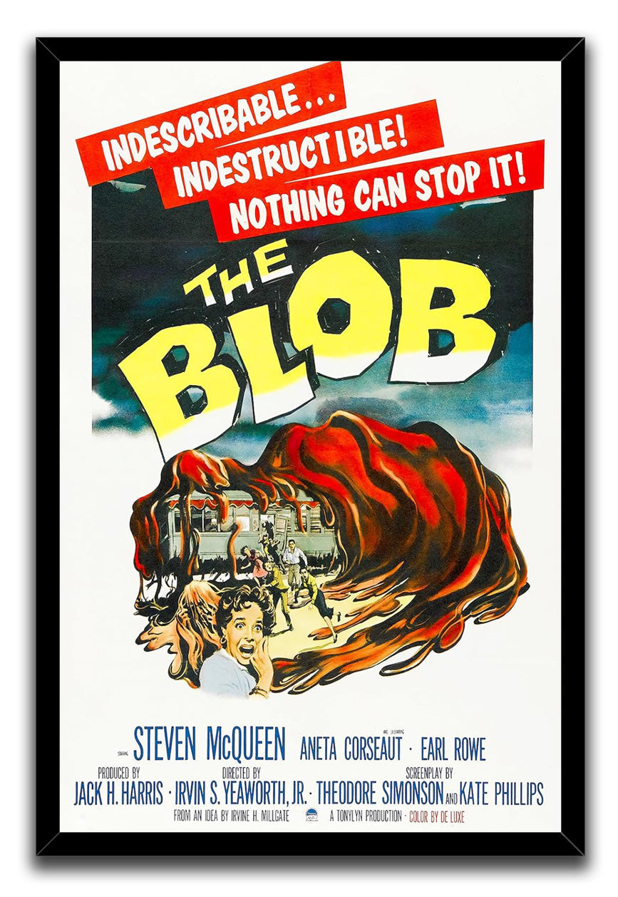 The Blob framed wall art print features a black frame, yellow title lettering, and a red-orange monster engulfing people.