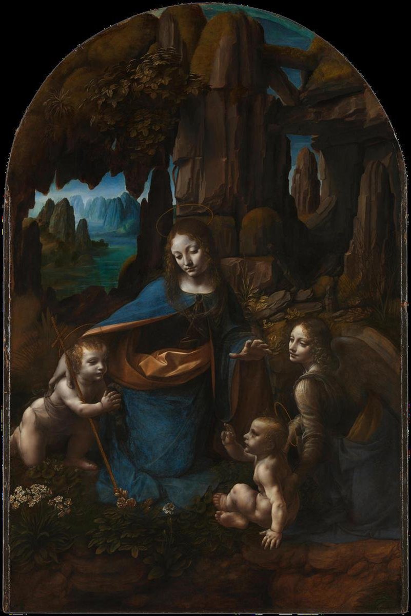 Virgin of the Rocks wall art print depicts Mary in blue with two infants and an angel inside a shadowy rocky grotto.