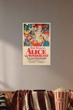 Walt Disney's Alice in Wonderland Movie Poster in a cozy movie room above a brown sofa with popcorn.