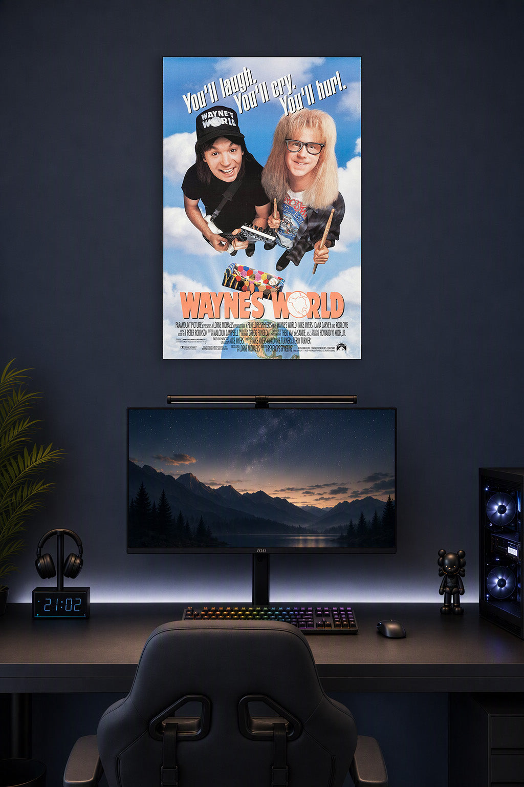 Wayne's World Movie in a gaming desk setup above a monitor.