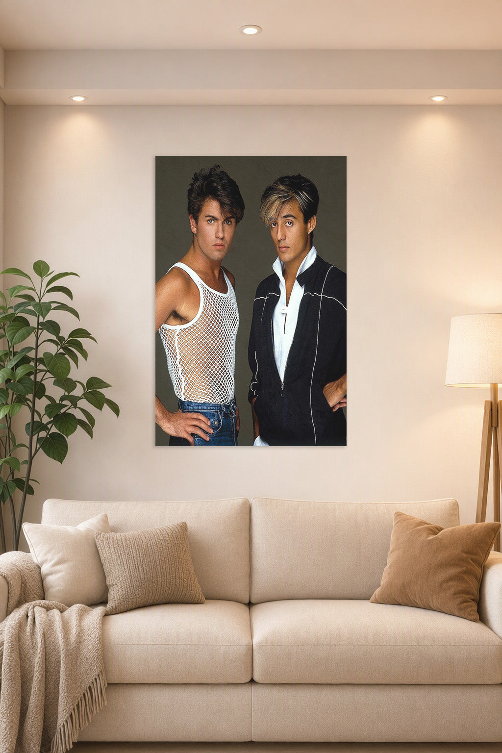 Wham! George Michael and Andrew Ridgeley in a bright living room above a beige sofa.