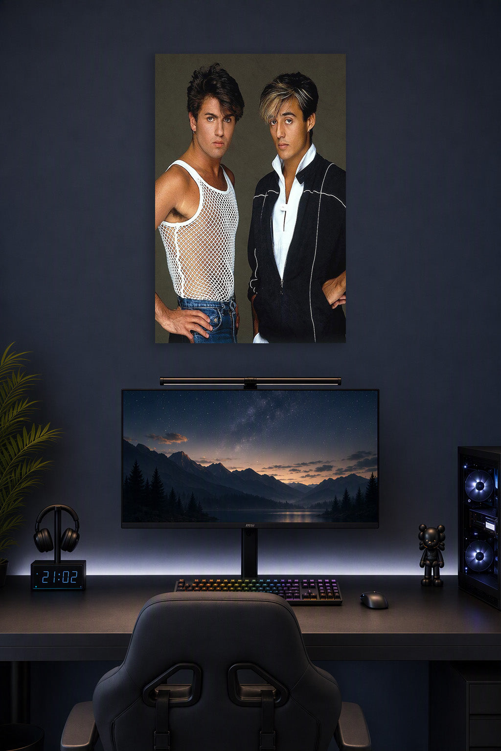 Wham! George Michael and Andrew Ridgeley in a gaming desk setup above a monitor.