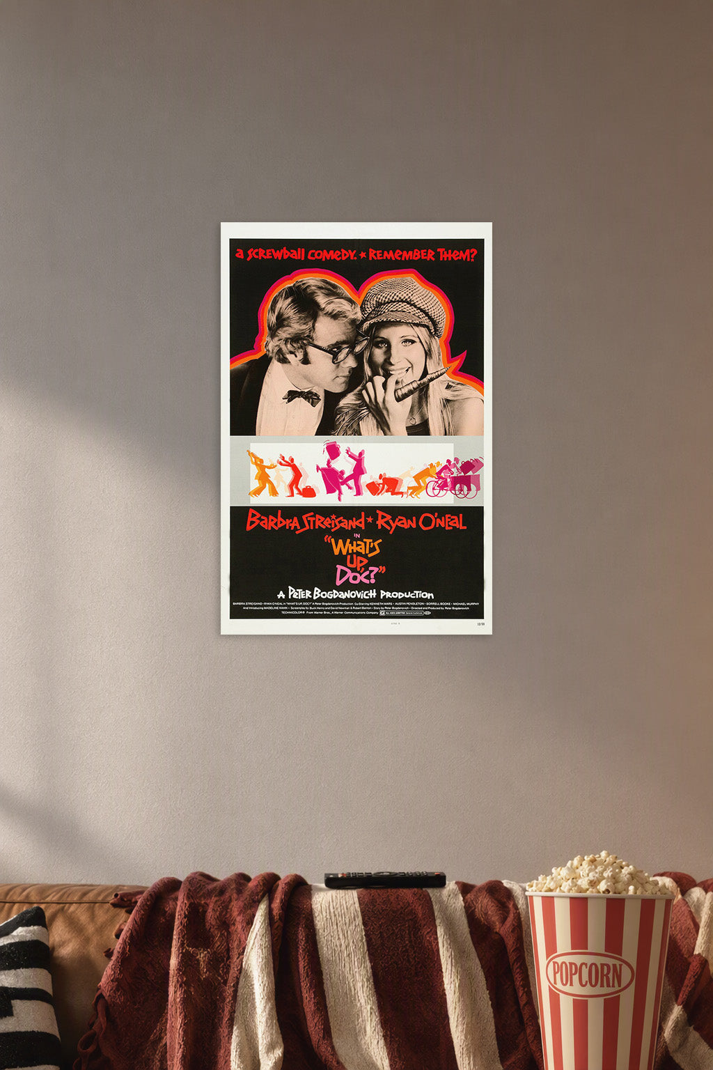 What's Up Doc? Barbra Streisand Ryan O'Neal Movie Poster in a cozy movie room above a brown sofa with popcorn.