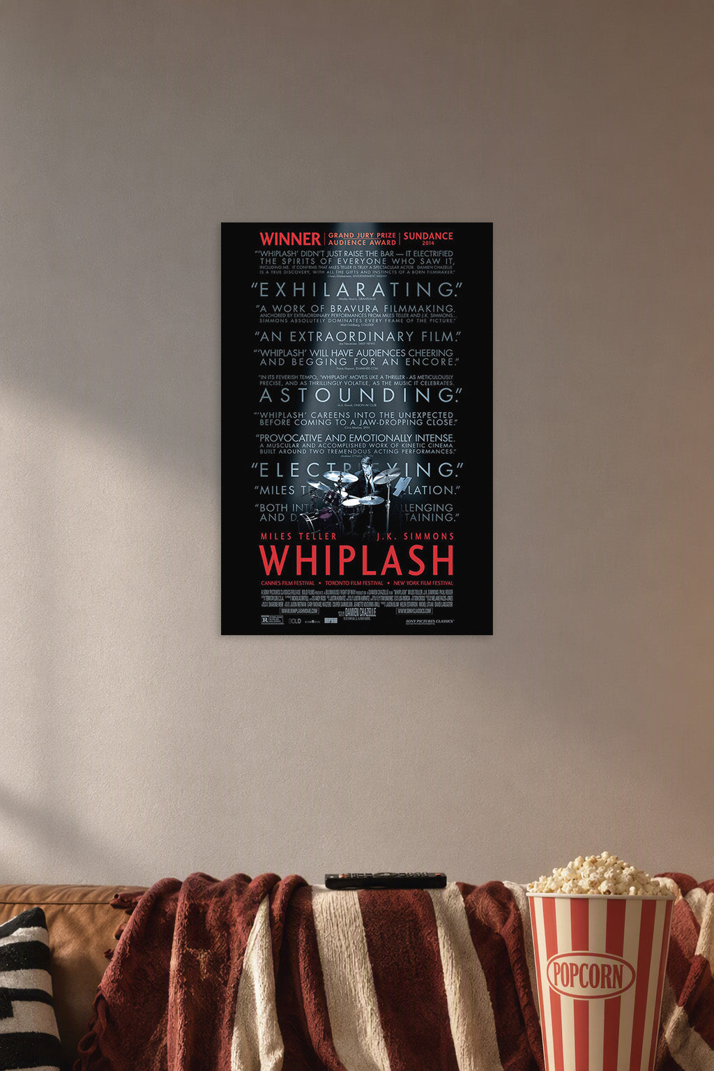 Whiplash Movie in a cozy movie room above a brown sofa with popcorn.