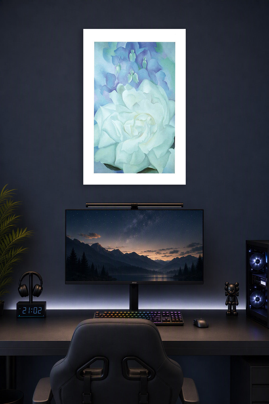White Floral Art in a gaming desk setup above a monitor.