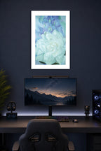 White Floral Art in a gaming desk setup above a monitor.