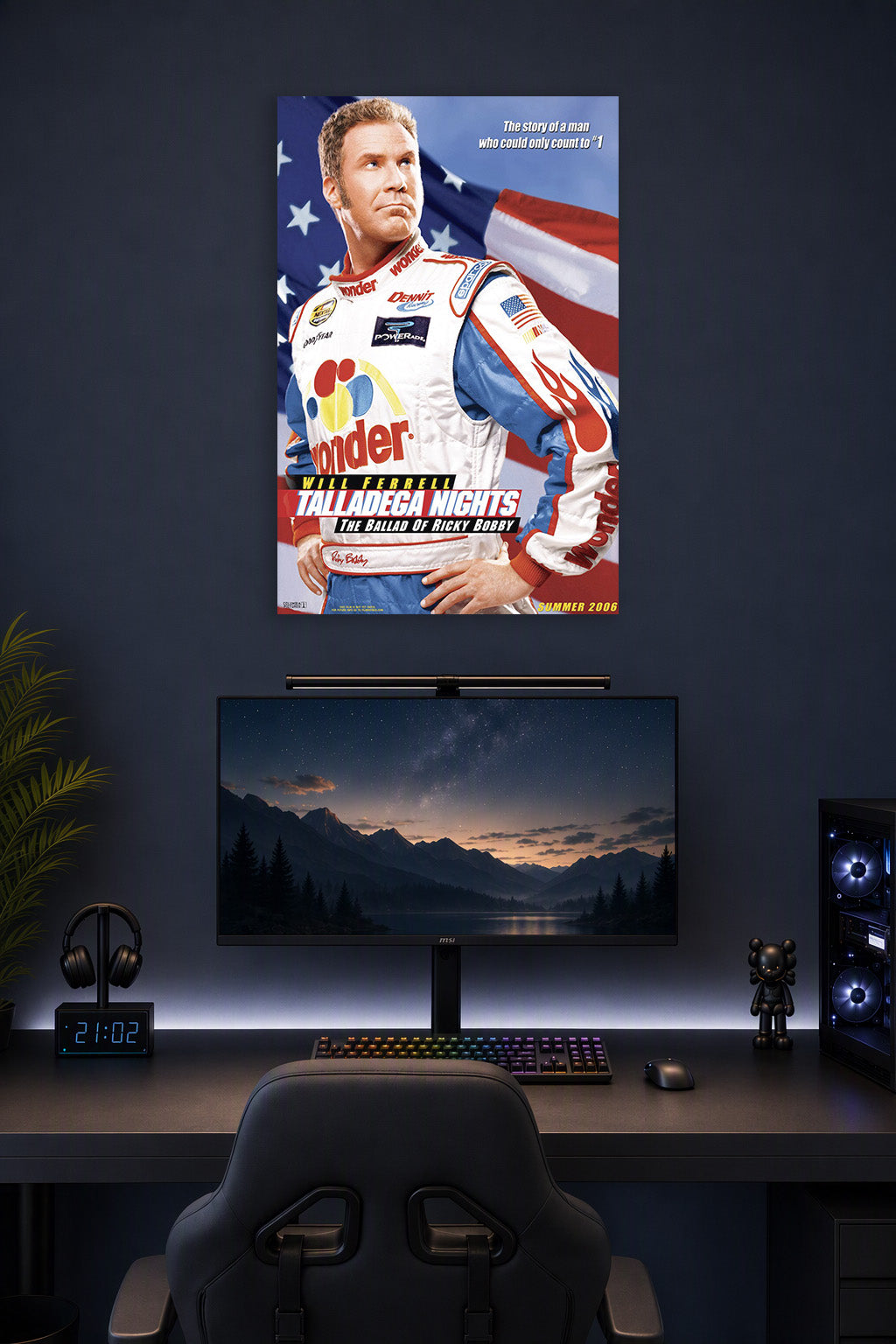 Will Ferrell Ricky Bobby Talladega Nights in a gaming desk setup above a monitor.