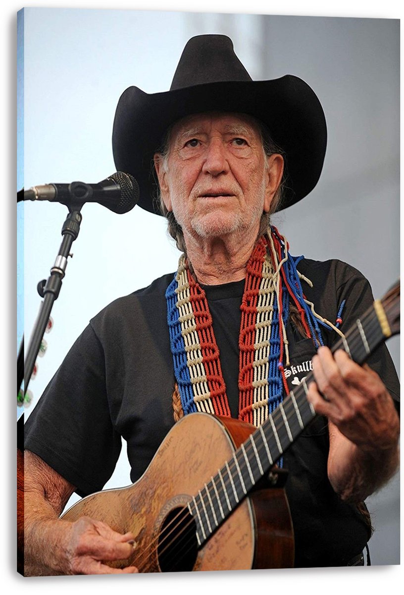 Willie Nelson canvas wall art print displays the singer in a black cowboy hat with guitar and red, white, and blue neckwear.