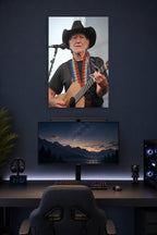 Willie Nelson in a gaming desk setup above a monitor.