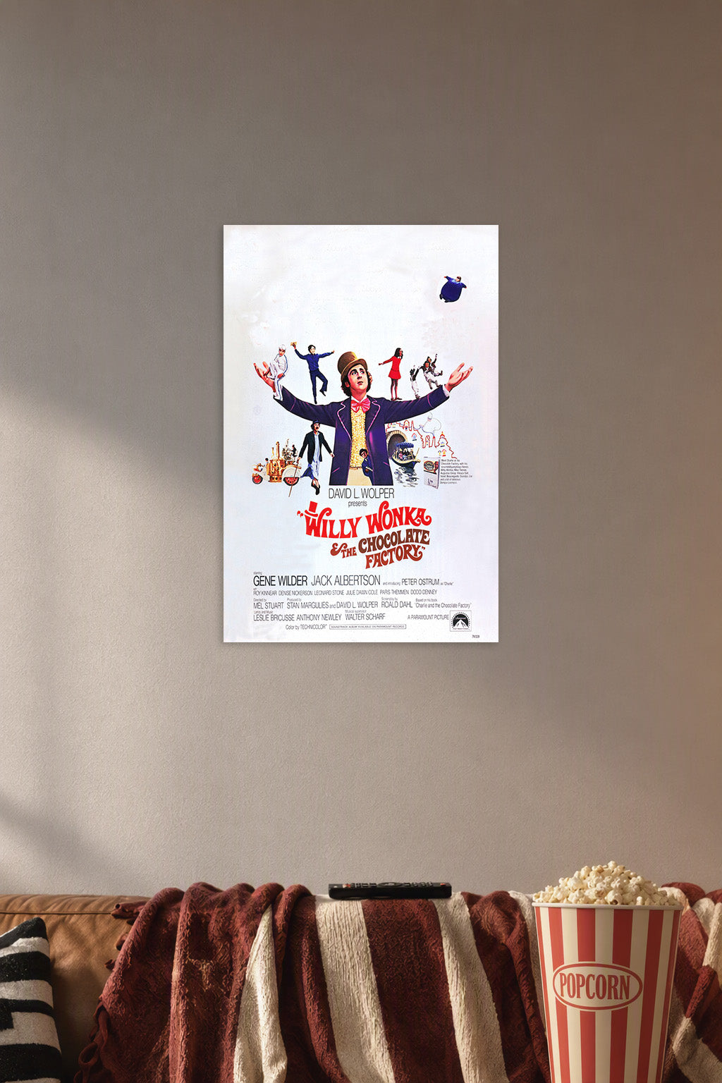Willy Wonka & The Chocolate Factory in a cozy movie room above a brown sofa with popcorn.
