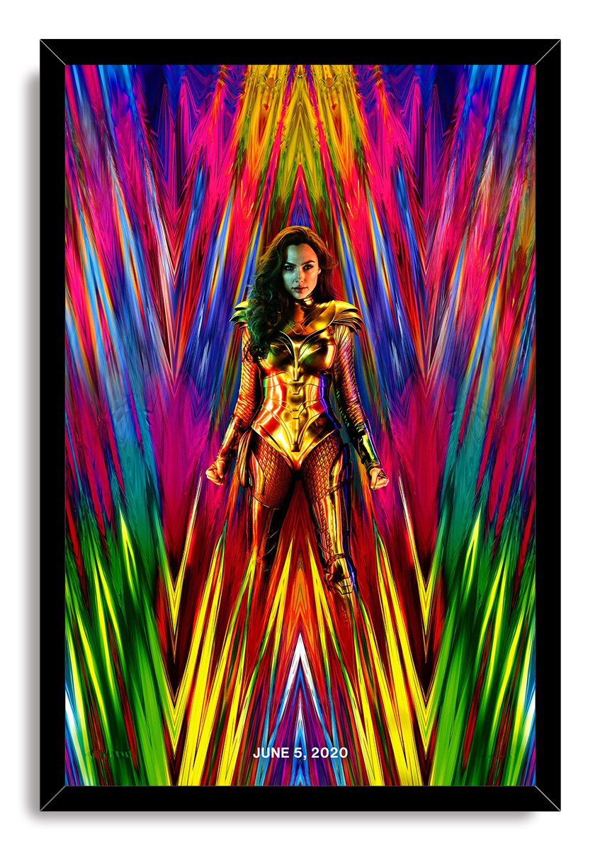 Wonder Woman framed wall art print depicts a warrior in gleaming gold armor holding swords amid bold geometric strokes in pink, blue, yellow, and green.