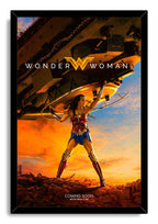 Wonder Woman framed wall art print features the heroine holding a tank aloft against a dramatic orange and blue sky.
