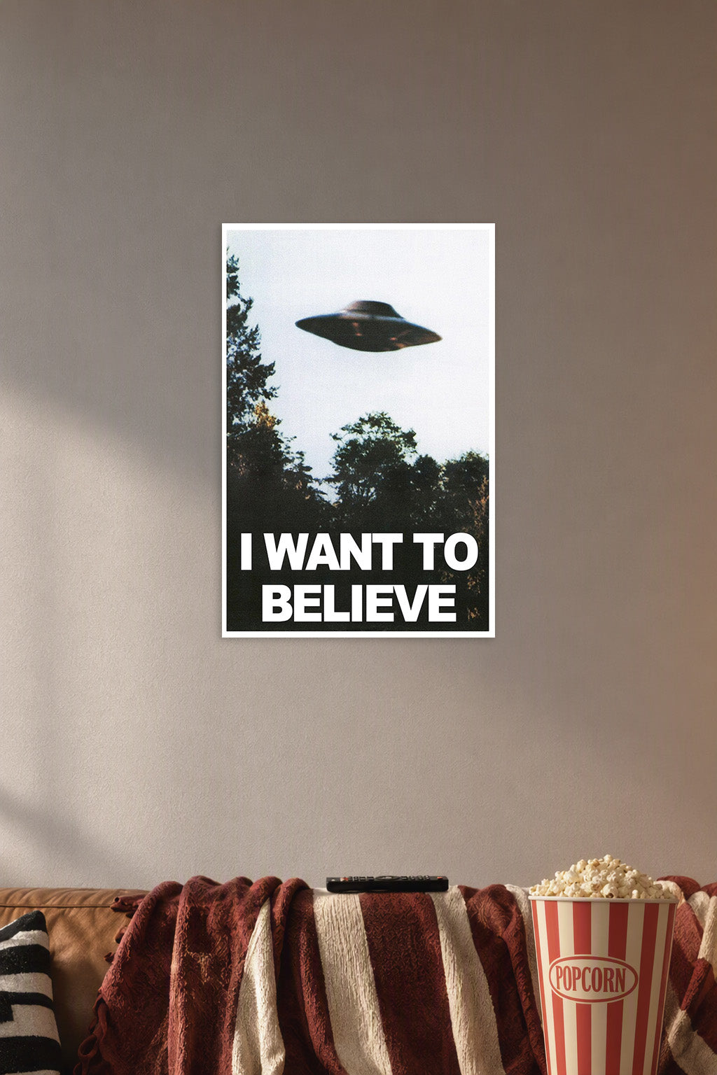 X-Files UFO I Want To Believe in a cozy movie room above a brown sofa with popcorn.