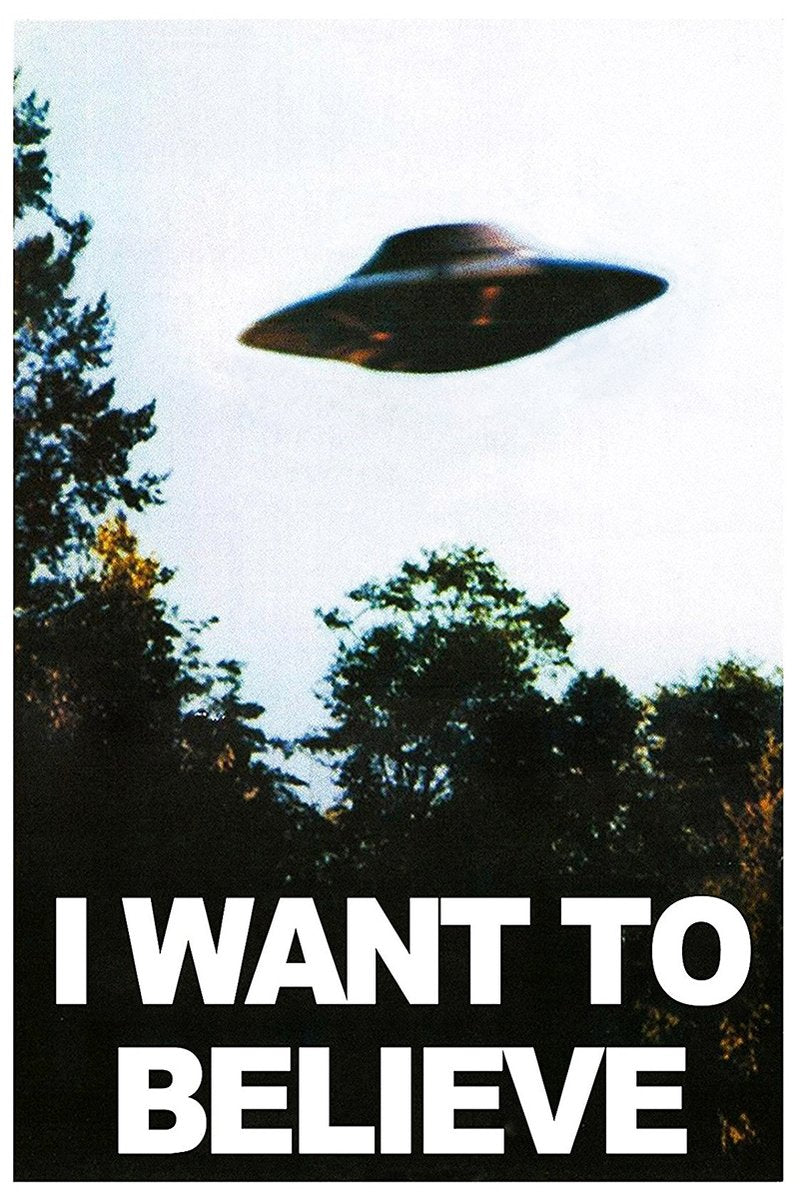 UFO poster featuring a dark flying saucer above shadowy green trees, with bold white "I WANT TO BELIEVE" text.