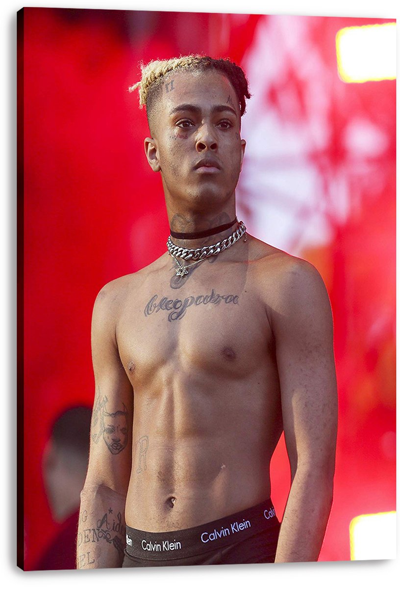 XXXTentacion canvas wall art print featuring the tattooed, shirtless rapper in layered necklaces before a glowing red backdrop.