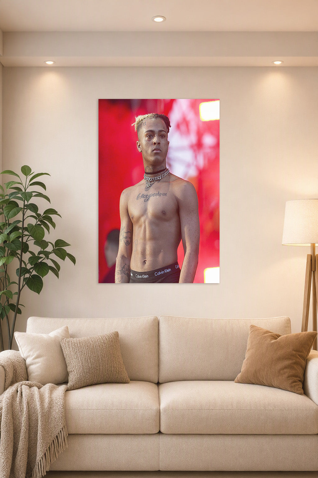 XXXTentacion in a bright living room above a beige sofa.