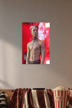 XXXTentacion in a cozy movie room above a brown sofa with popcorn.