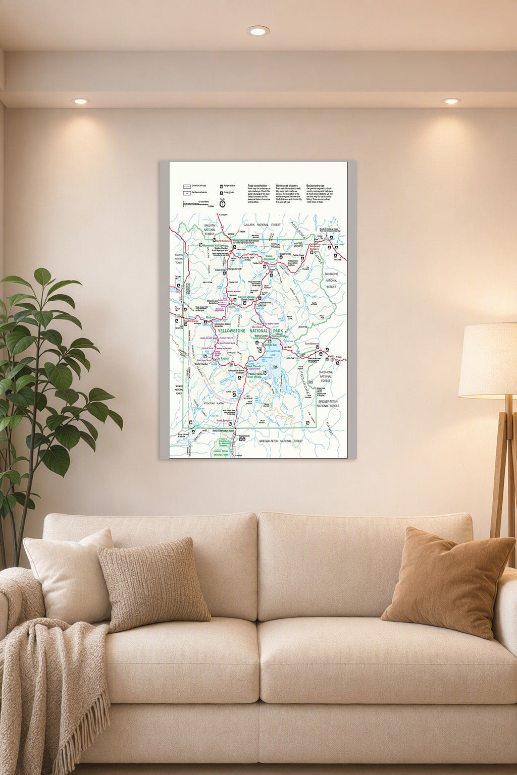 Yellowstone National Park Map in a bright living room above a beige sofa.