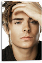 Zac Efron canvas wall art print featuring a close-up portrait, raised hand, brown hair, and a white background.