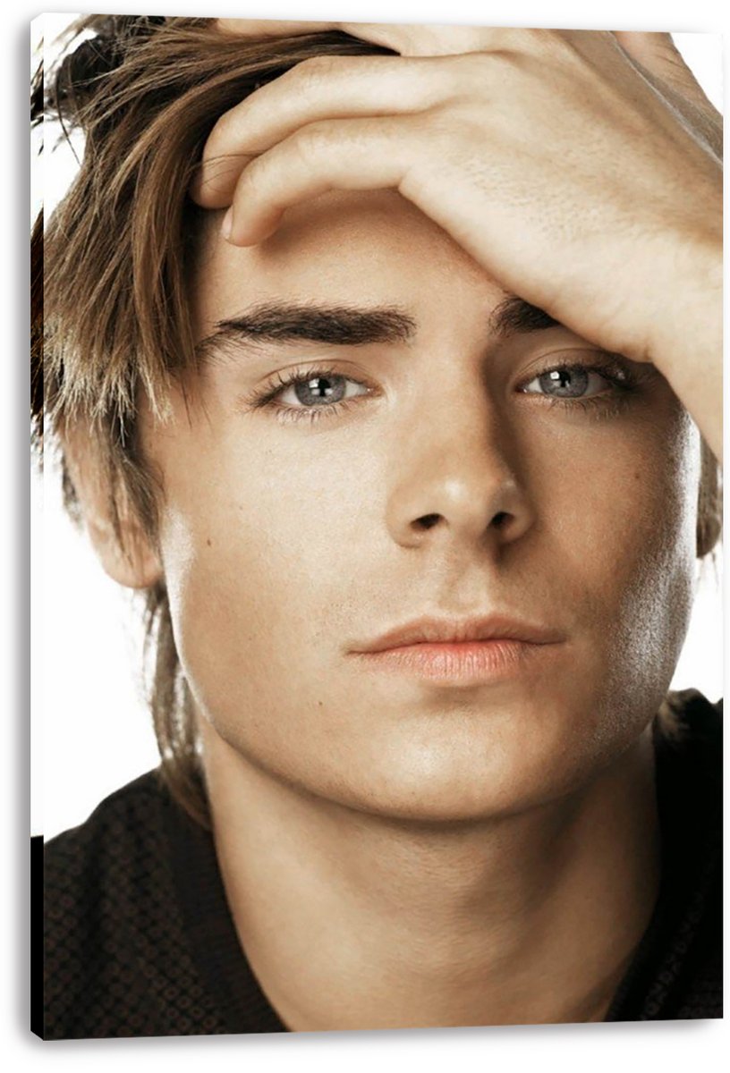 Zac Efron canvas wall art print featuring a close-up portrait, raised hand, brown hair, and a white background.