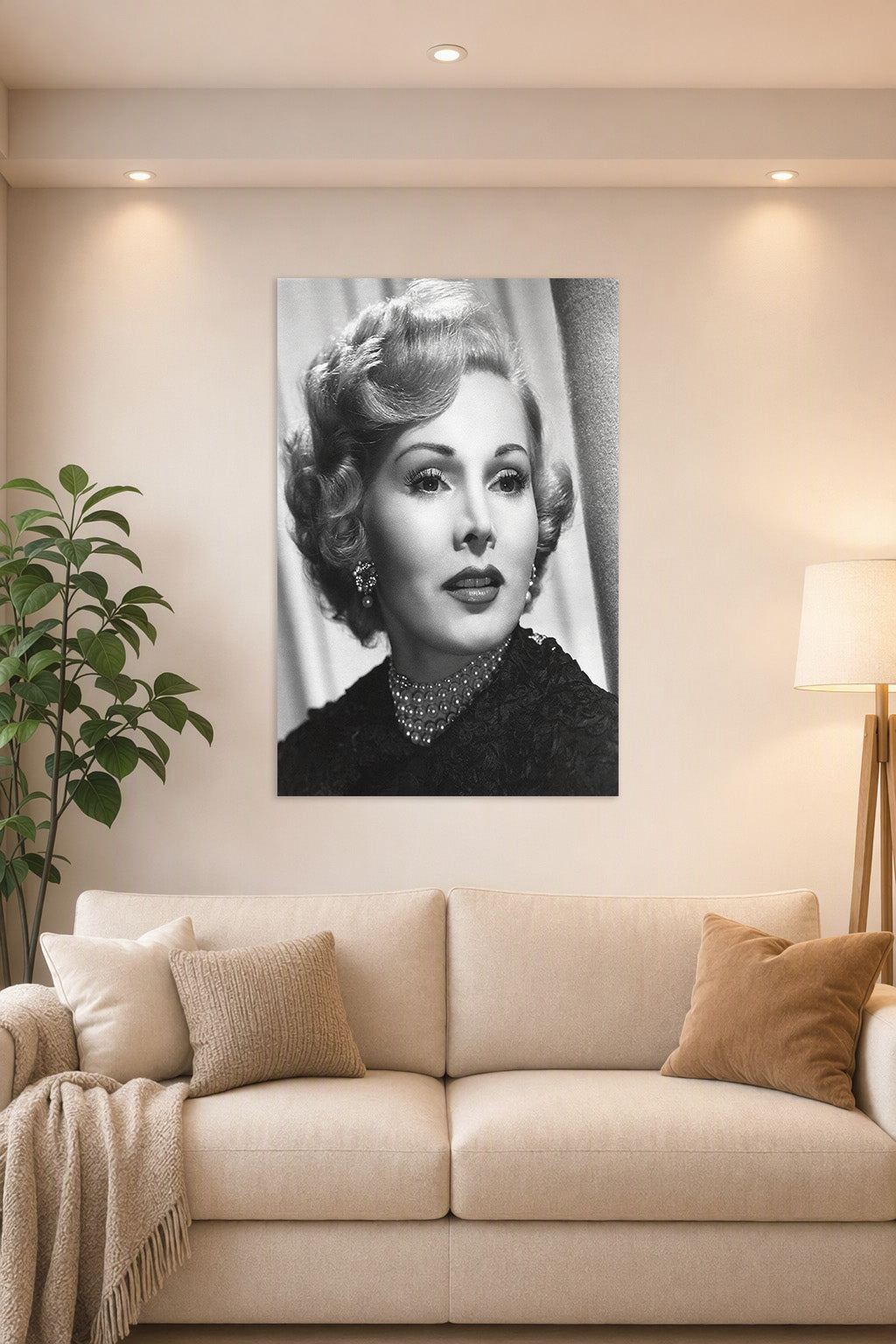 Zsa Zsa Gabor in a bright living room above a beige sofa.