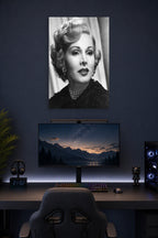 Zsa Zsa Gabor in a gaming desk setup above a monitor.