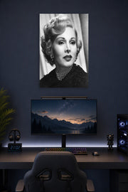 Zsa Zsa Gabor in a gaming desk setup above a monitor.