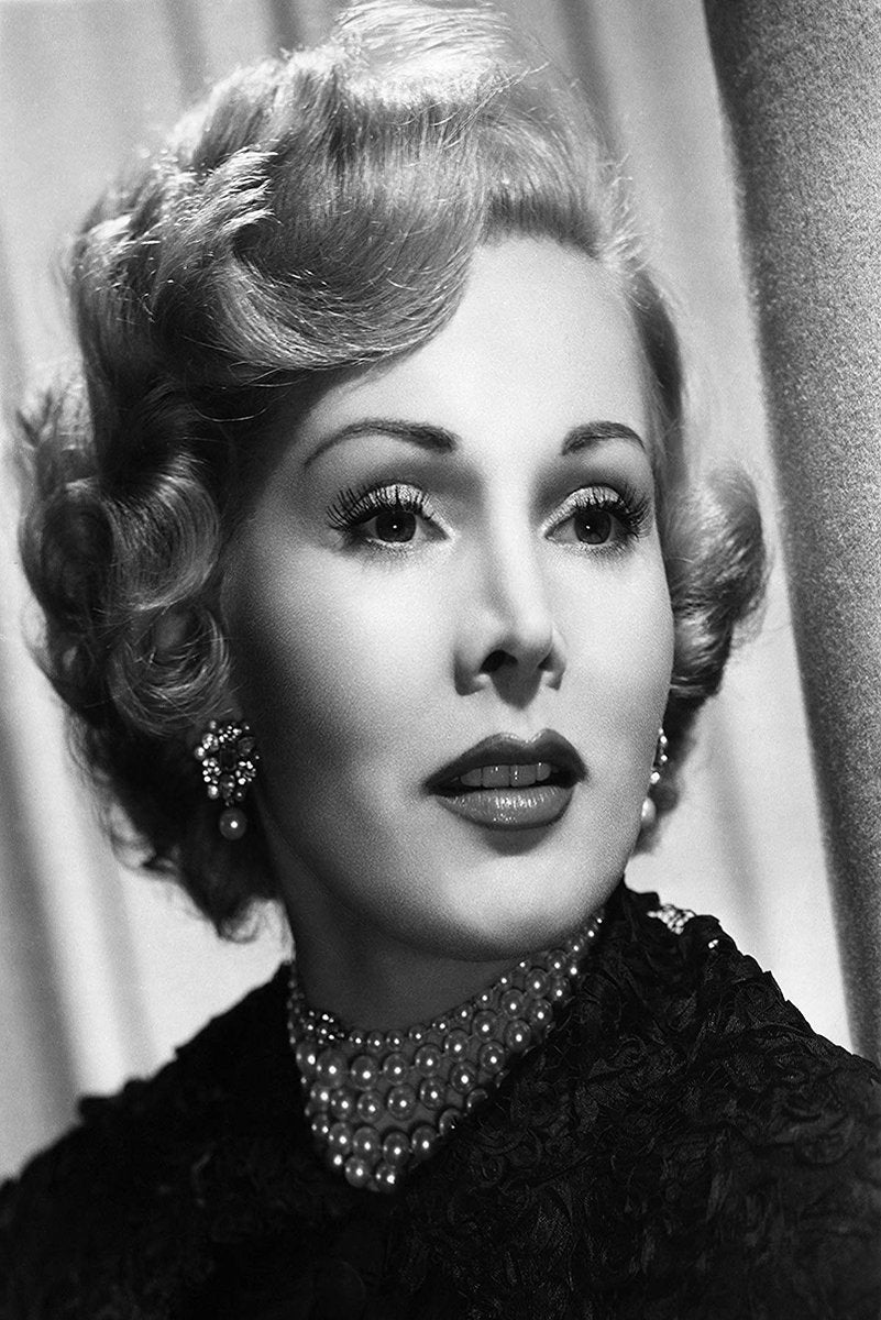 Zsa Zsa Gabor poster features a black-and-white close-up portrait with curled hair, pearl necklace, jeweled earrings, and dark gown.