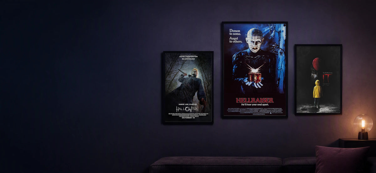 Hellraiser, Halloween and IT framed posters displayed in a dark violet movie lounge.